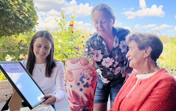 Die stellvertretende Vorsitzende Theresia Oelgemöller (Bildmitte) überreicht die Urkunde des Landersverbandes und Geschenke unseres Vereins an Liesbeth D. und ihre Enkelin Jorina.